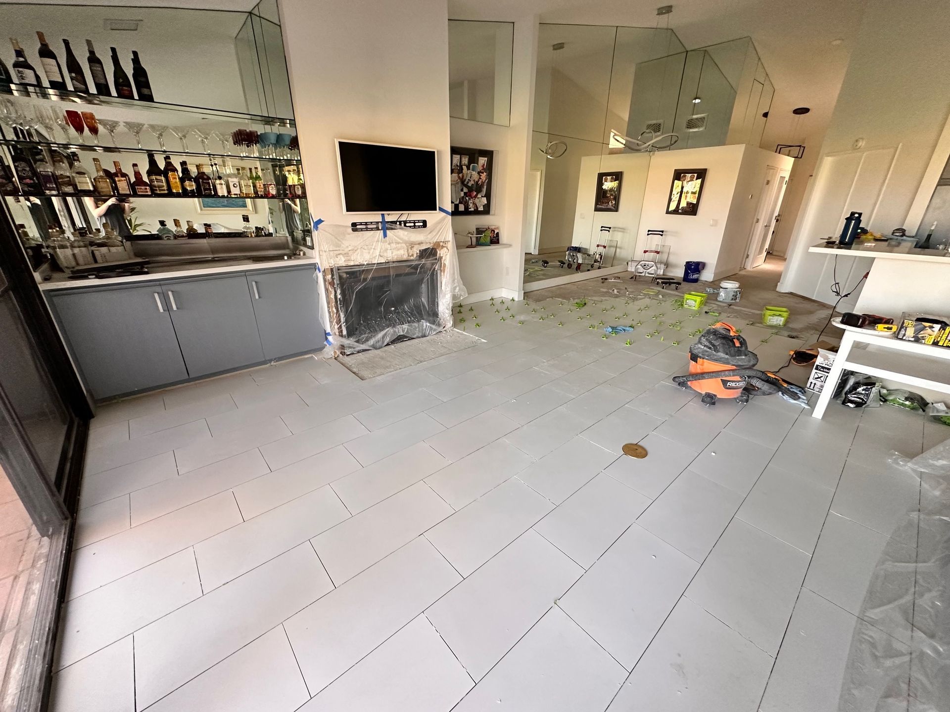 Gray-tiled room with a bar