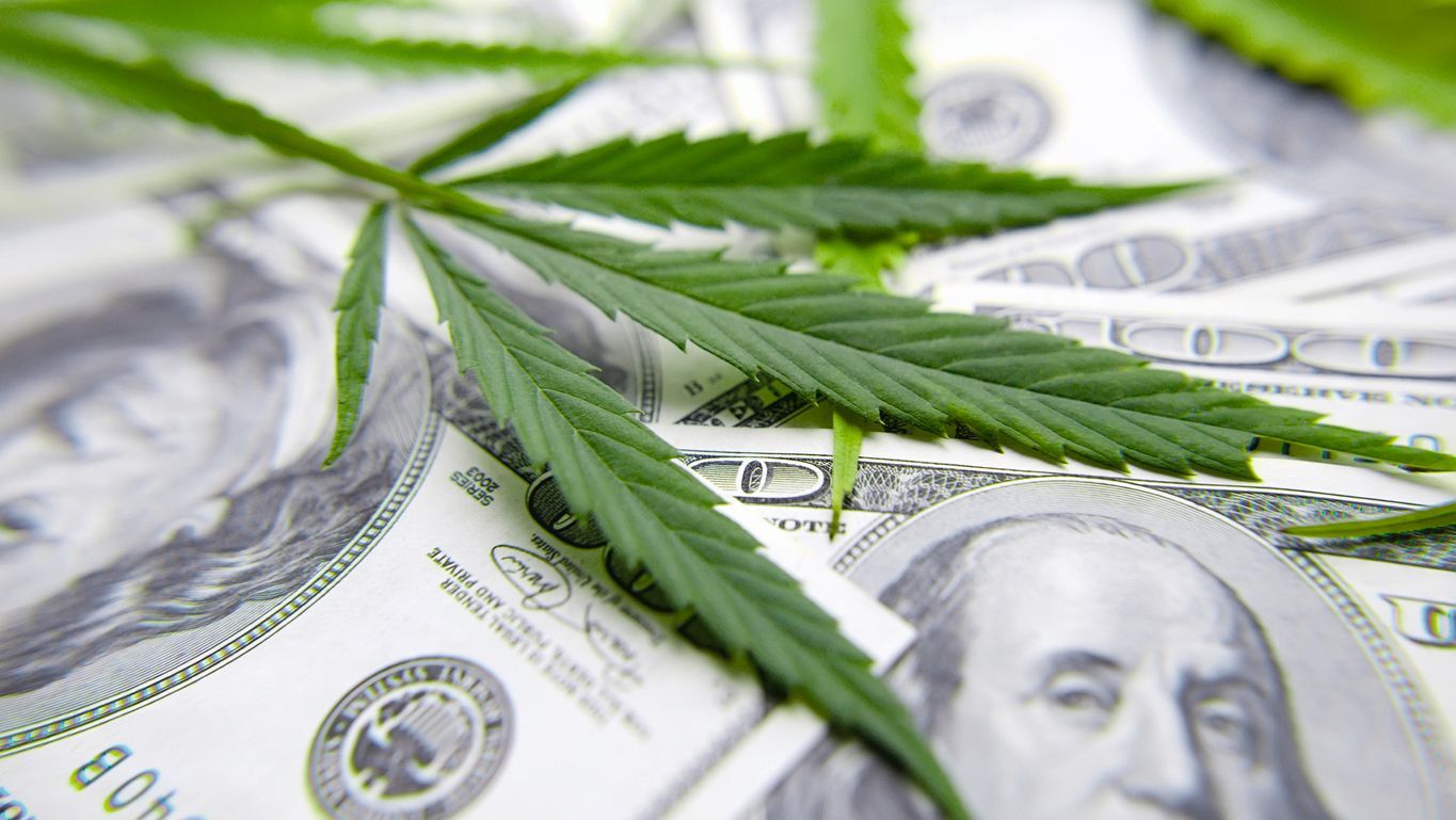 cannabis-leaf-on-set-of-100-dollar-bills