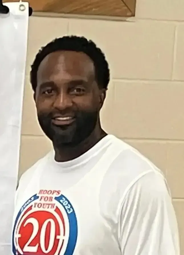 A man wearing a white shirt with the number 20 on it