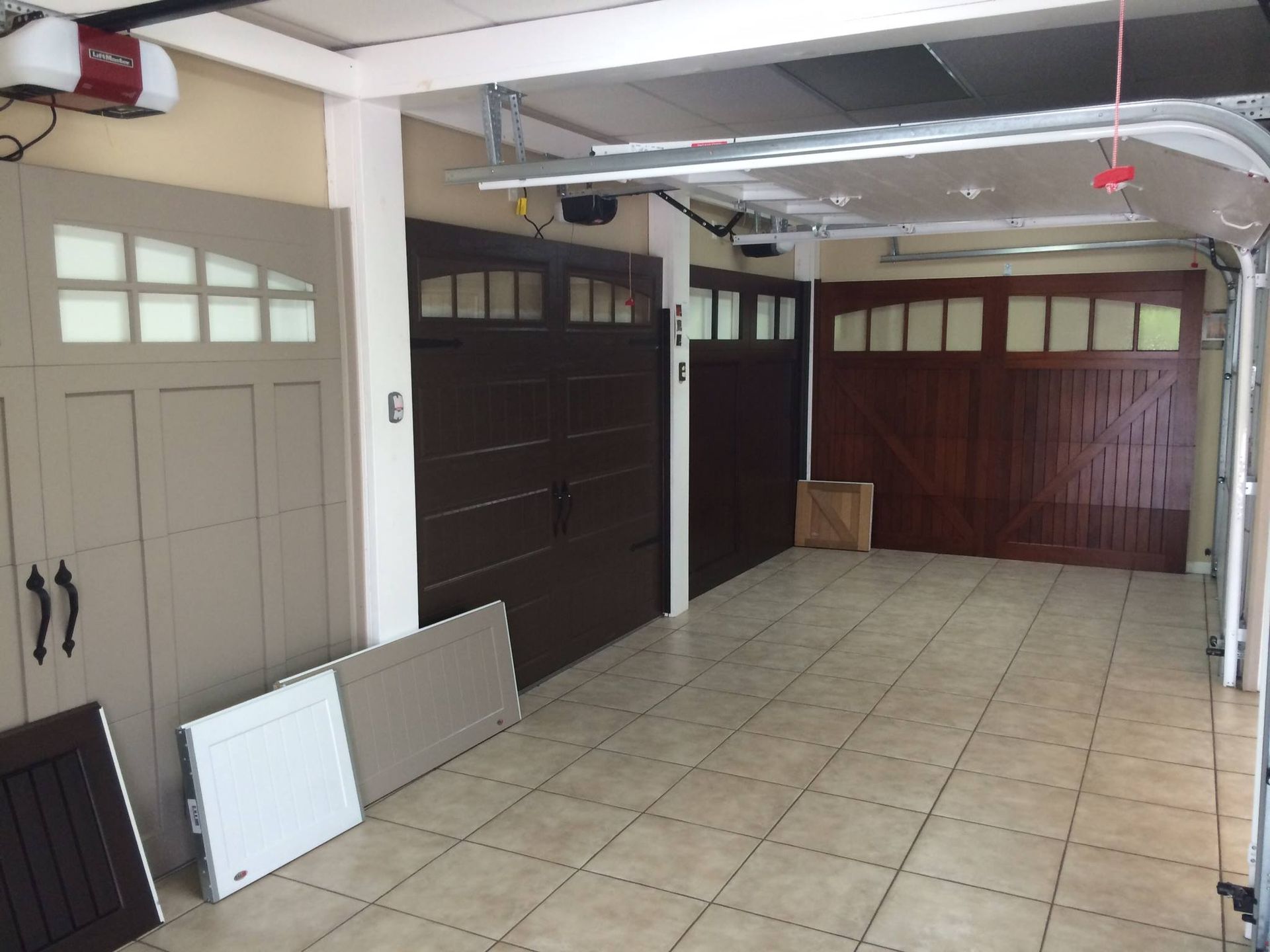 A garage with a lot of garage doors and a tiled floor