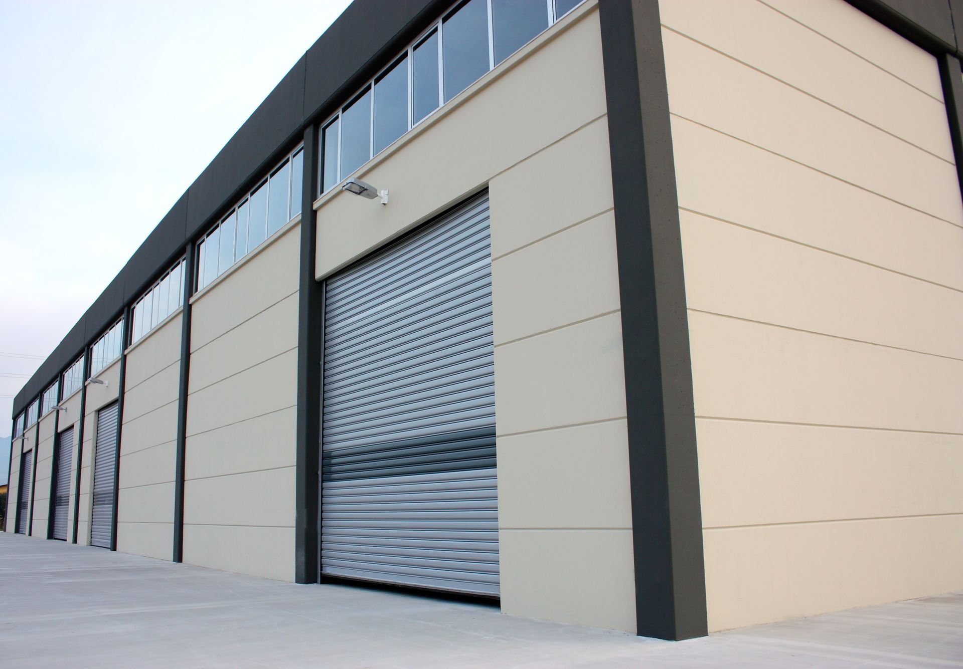 A building with a roller shutter on the side of it