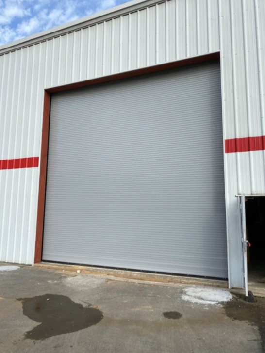 A white building with a large garage door