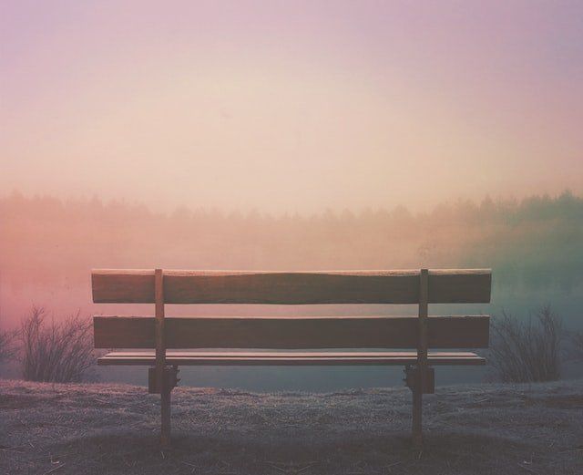 empty bench at sunset why successful people die by suicide