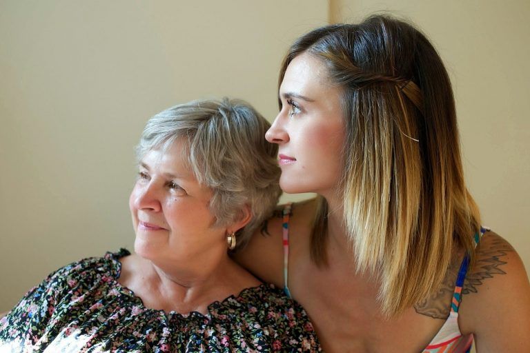 younger woman with arm around older woman family pay out of pocket for therapy