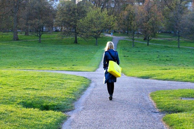 Woman walking away on a path due to stressful life event