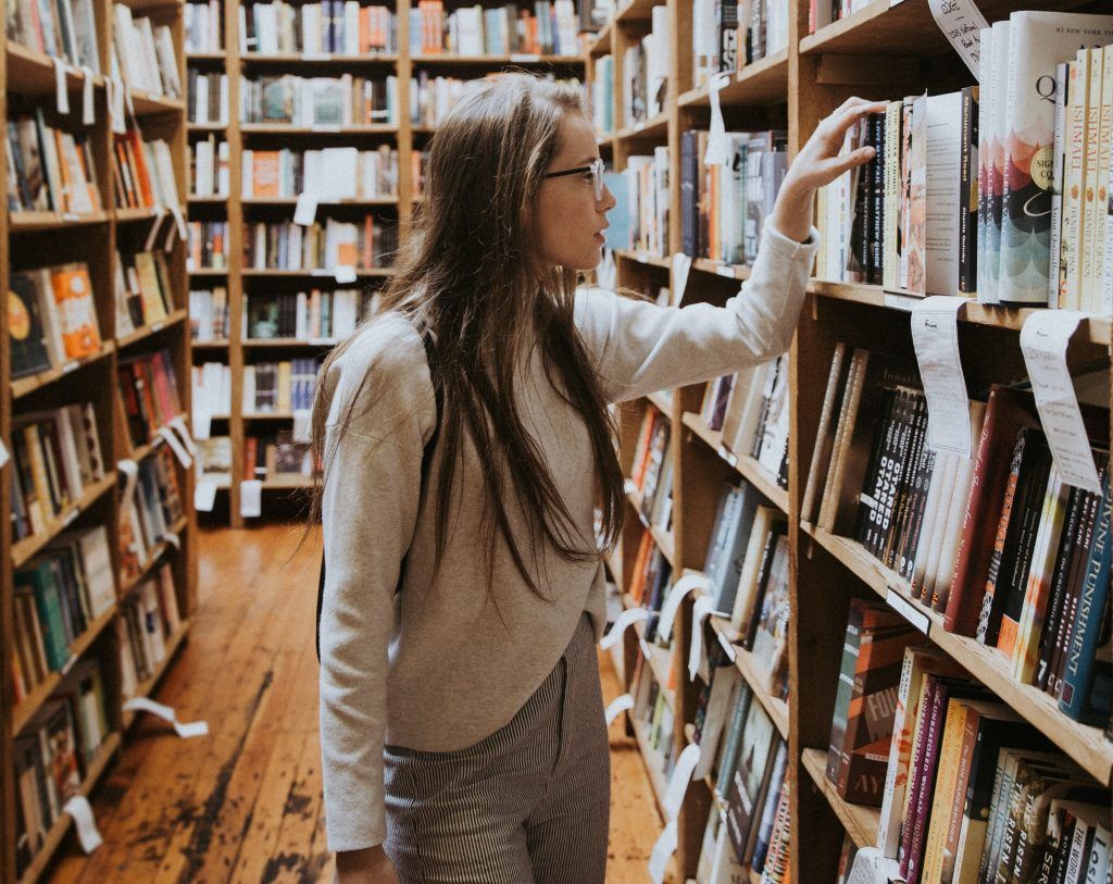girl in book shop looking through books for things  you don't do to treat OCD