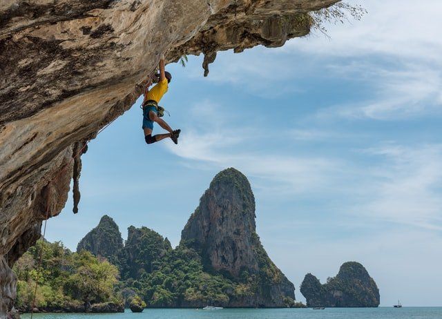 man mountain climbing overcoming challenges