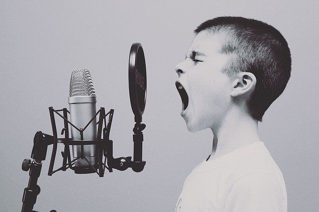 boy yelling into microphone due to stress and anger