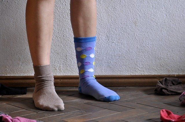 person's feet with mismatched socks for how to get things done when you don't feel like it