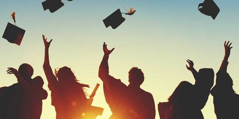 new grads in gowns tossing caps in air anxiety in new high school and college graduates