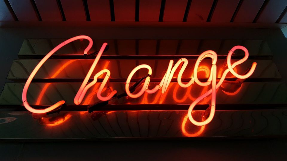 neon sign that says change for accepting change to deal with the unexpected