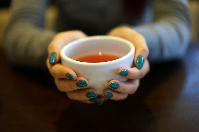 woman's hands around cup of tea for easy self care