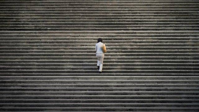 woman walking up stairs to make progress