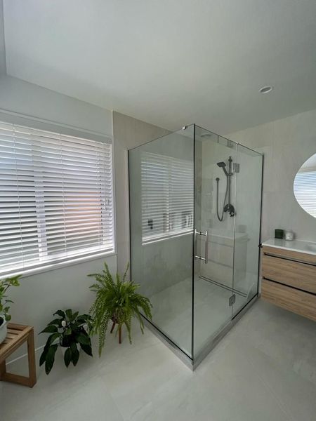 a bathroom with a walk in shower and a sink .