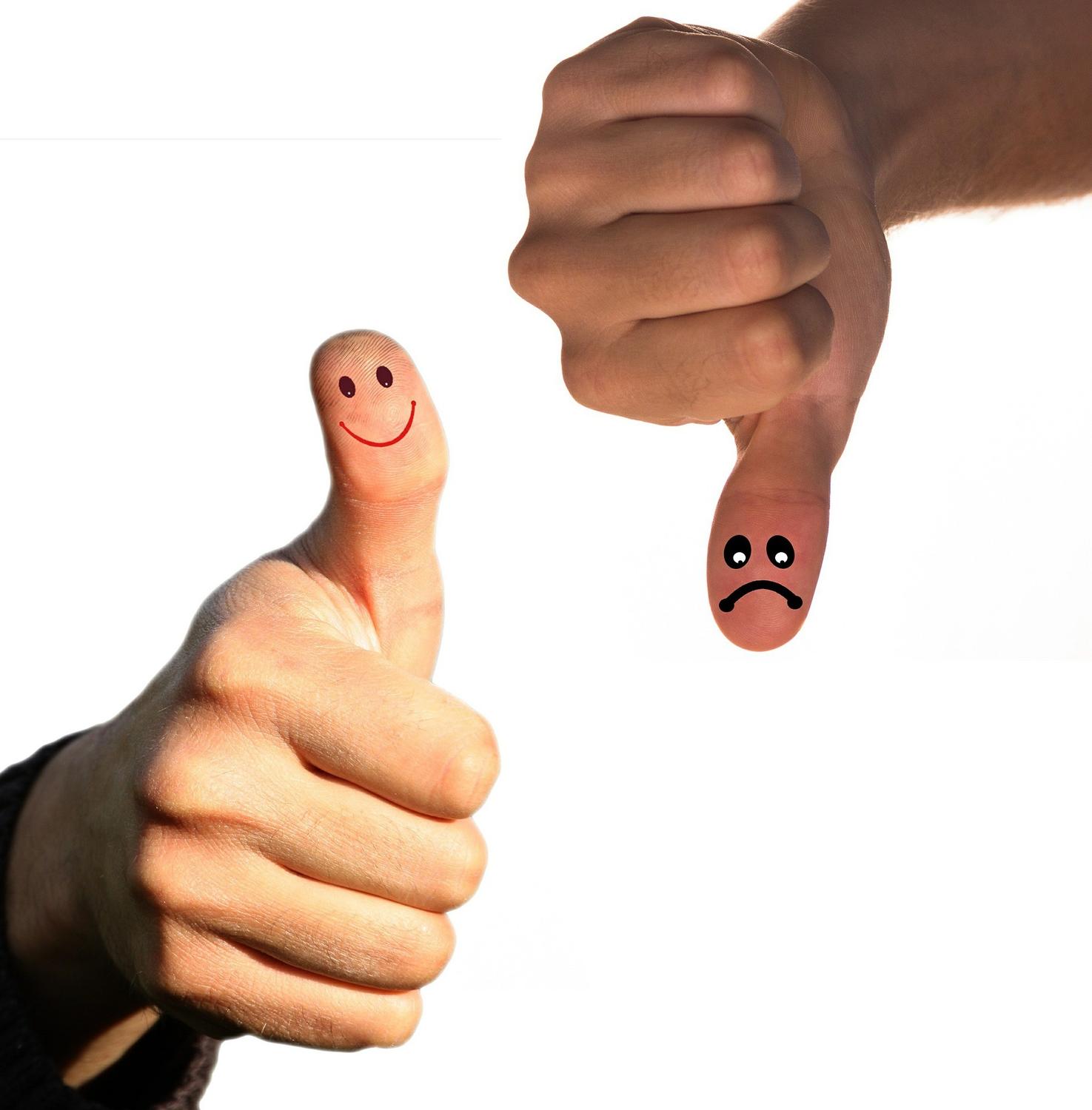 A person giving a thumbs up and another person giving a thumbs down