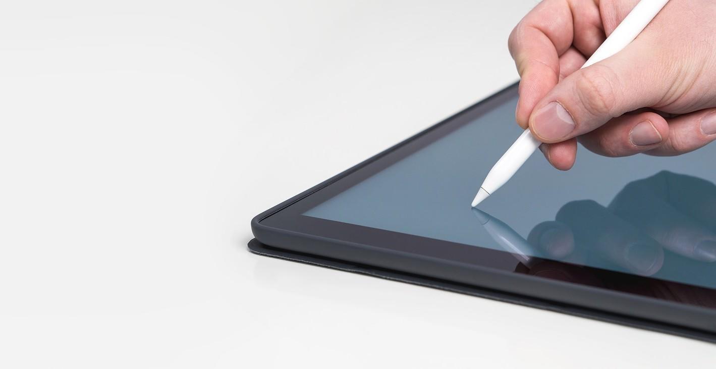A person is using a pencil on a tablet.