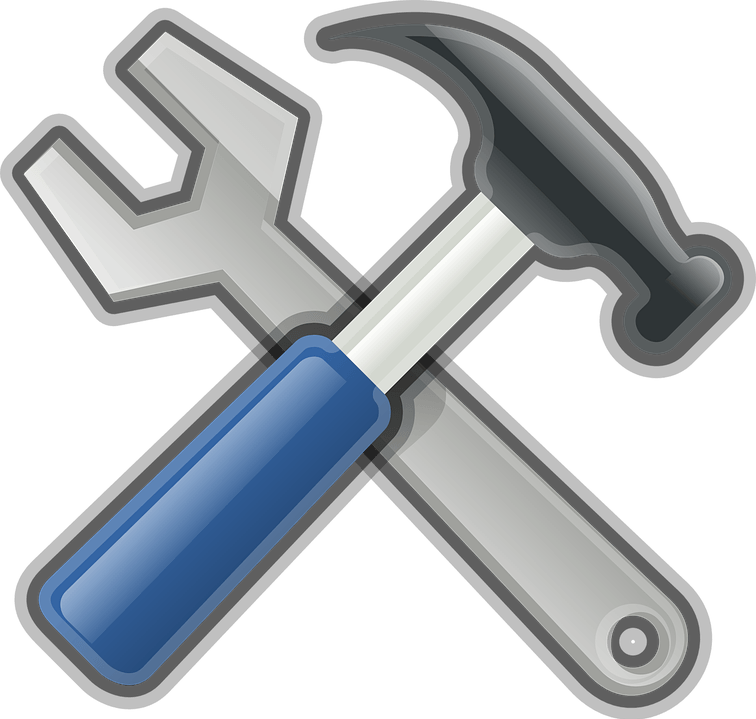 A wrench and hammer crossed over each other on a white background