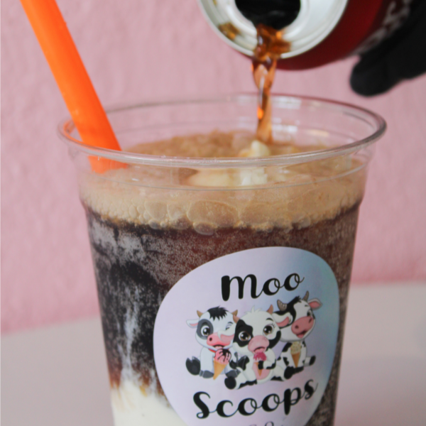 An ice cream float in a cup.