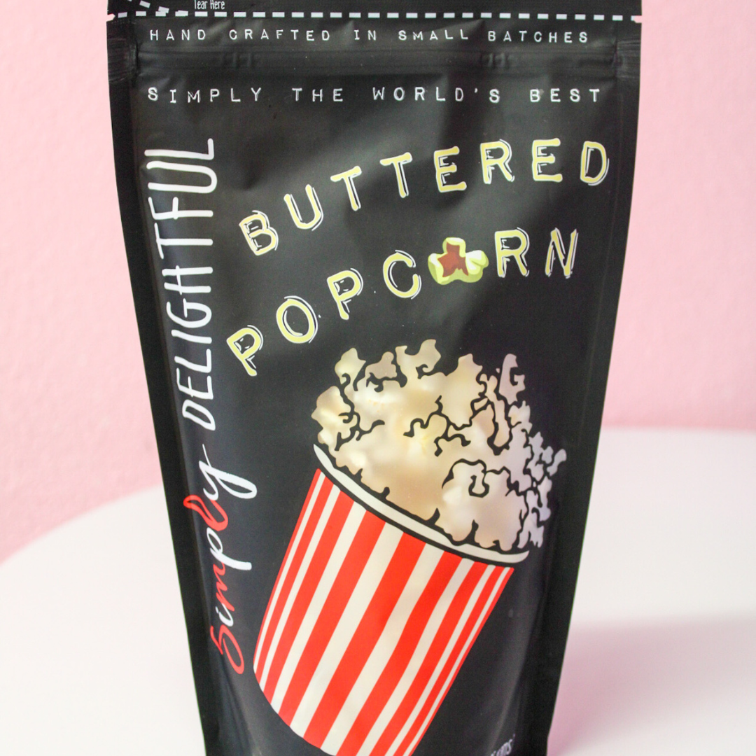 A bag of buttered popcorn is sitting on a table