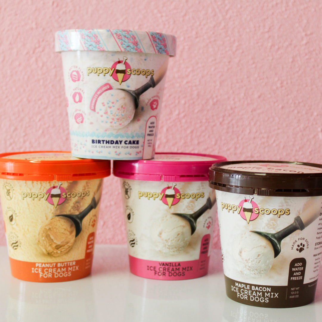 Four different flavors of scoops ice cream are lined up on a table