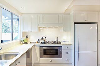 Completed kitchen design project with white kitchen cabinets