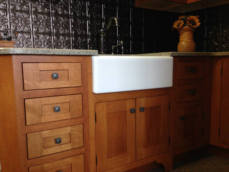 Kitchen design with dark tile backsplash and wood kitchen cabinets