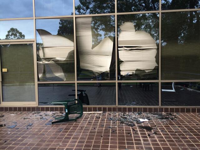 Shattered window glass being removed for replacement by Aussie Emergency Glass, a top choice for glass repair.