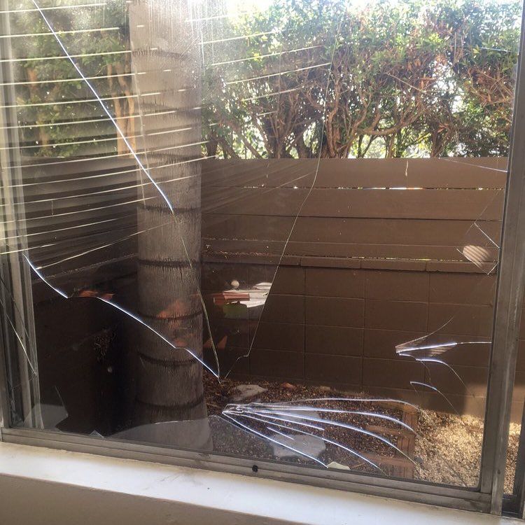 A broken window pane ready for glass replacement by Aussie Emergency Glass, trusted since 1997.