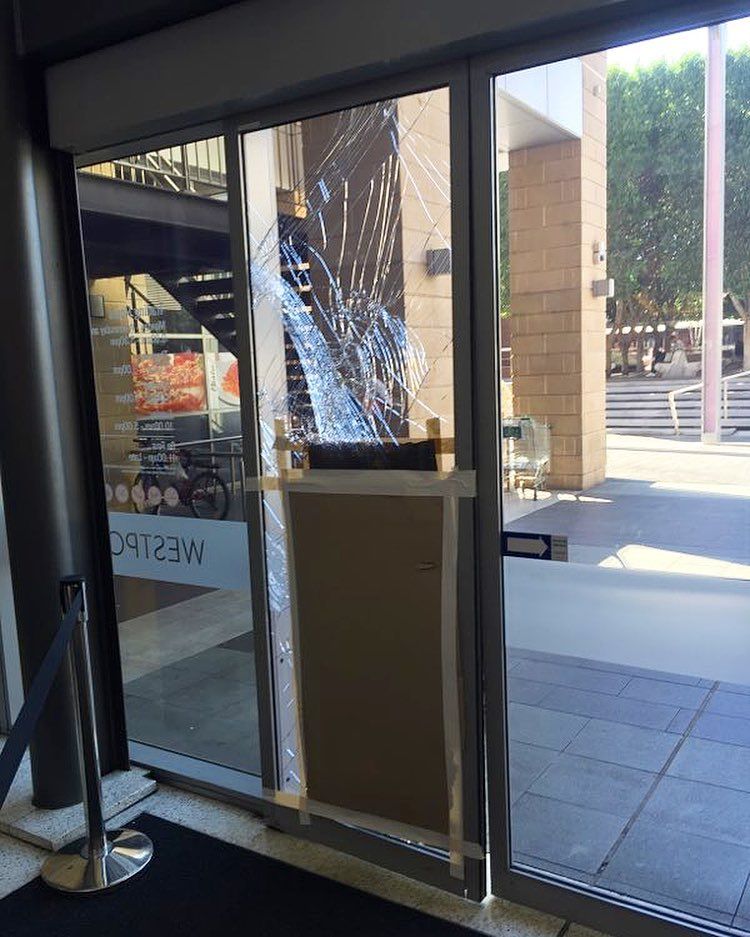 Repairing a cracked glass door, with Aussie Emergency Glass providing professional replacement services.