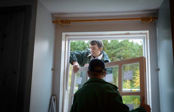 men replacing window