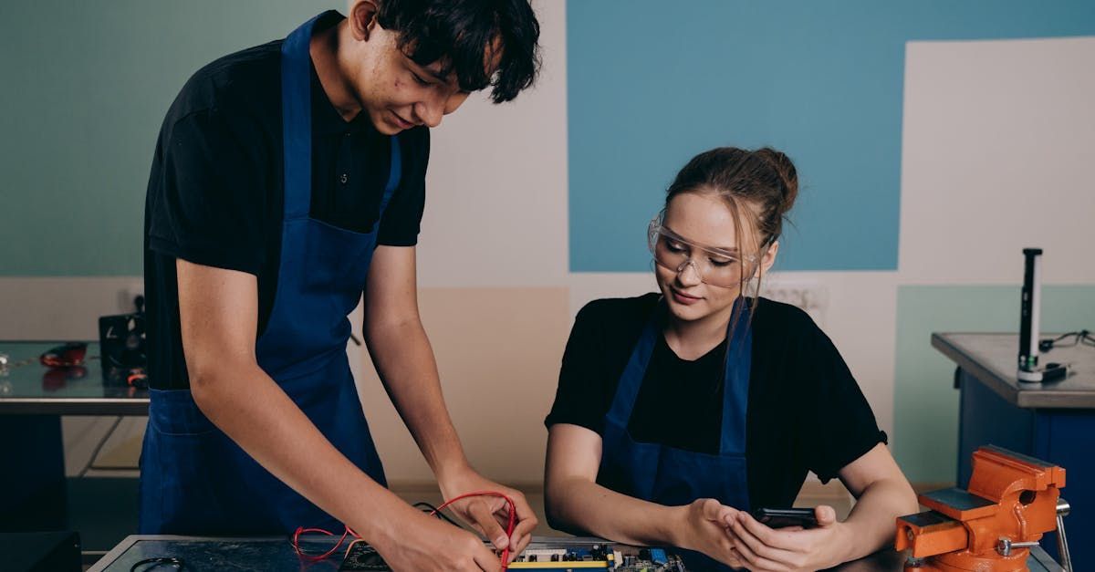 A man and a woman are working on a project together in a workshop.