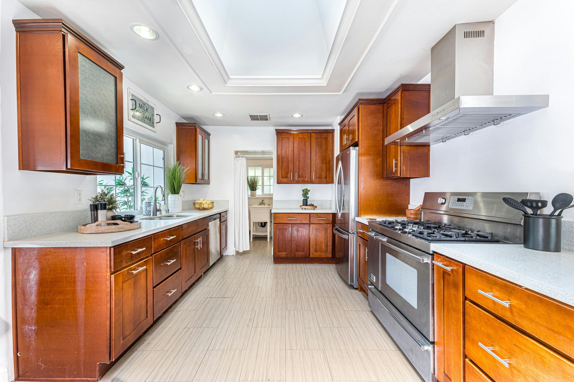 Kitchen with brown cabinets, stainless steel appliances, and white countertops.