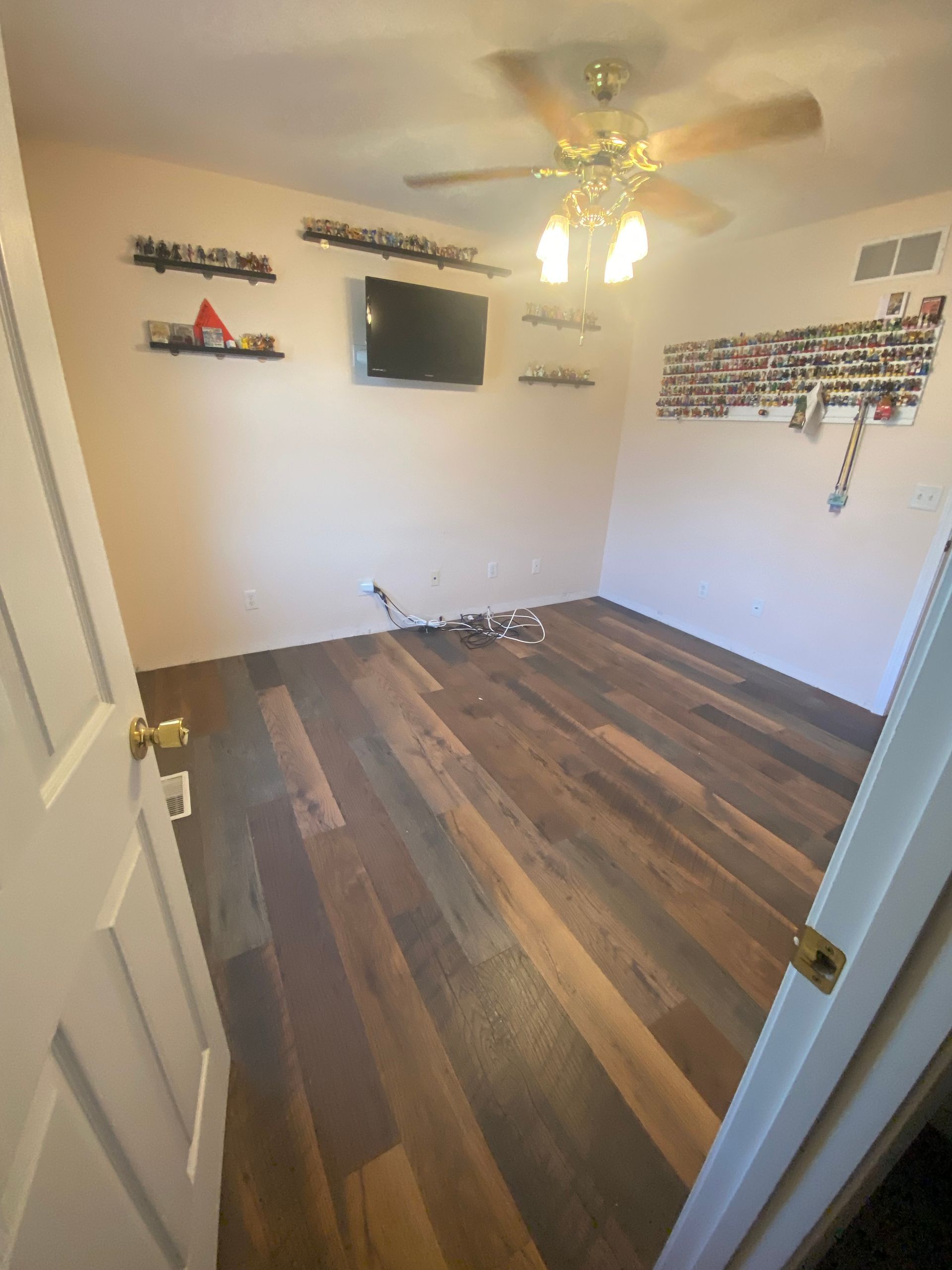 Kitchen counter with a microwave on top and an open cabinet door below.