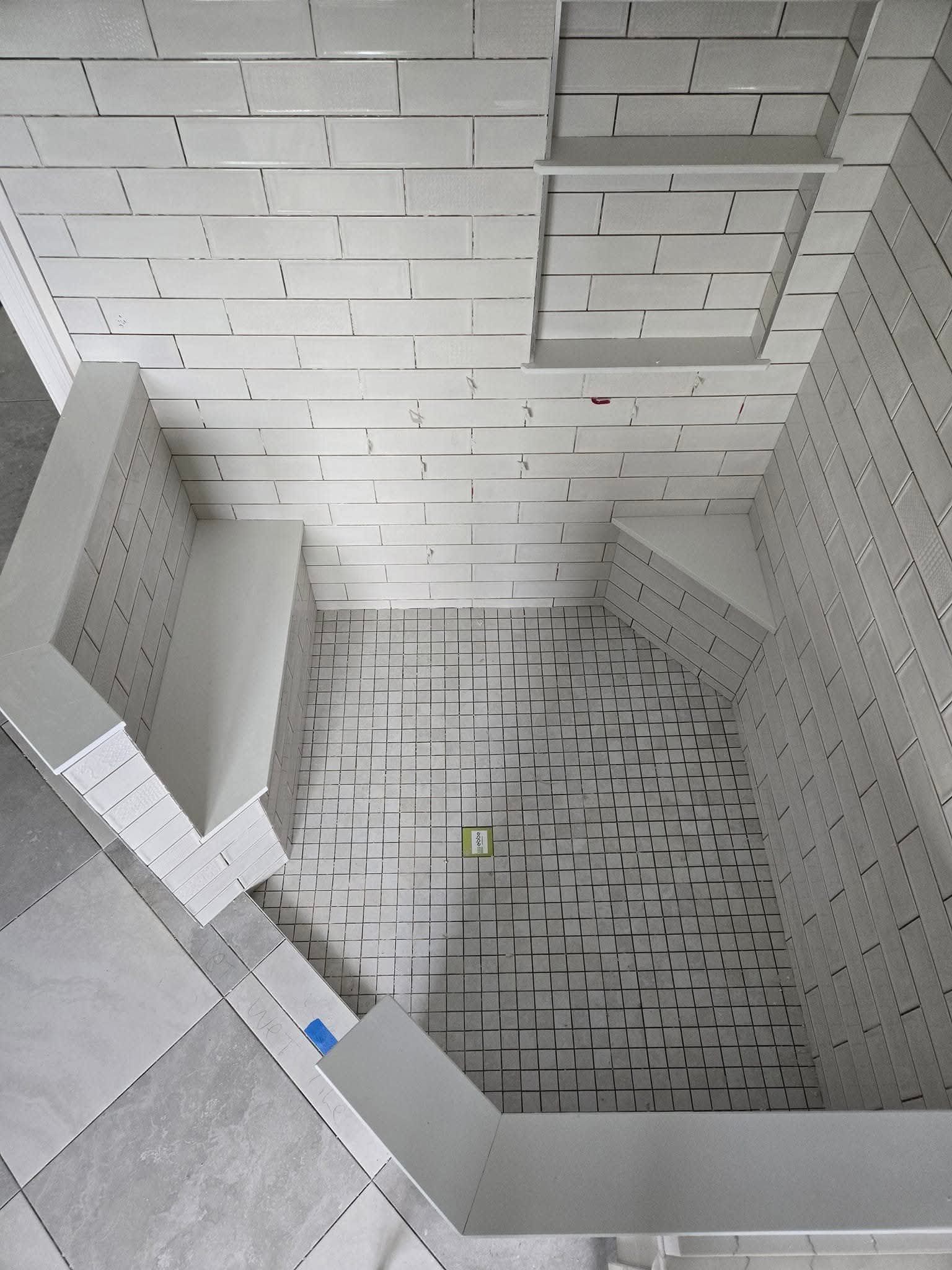 A room with tiled walls and ceiling; angled view.