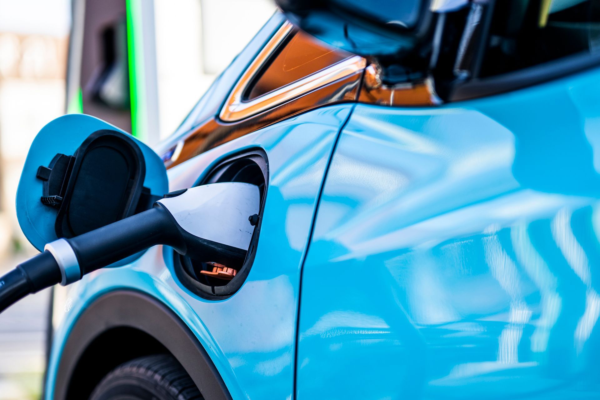 A blue electric car recharges.