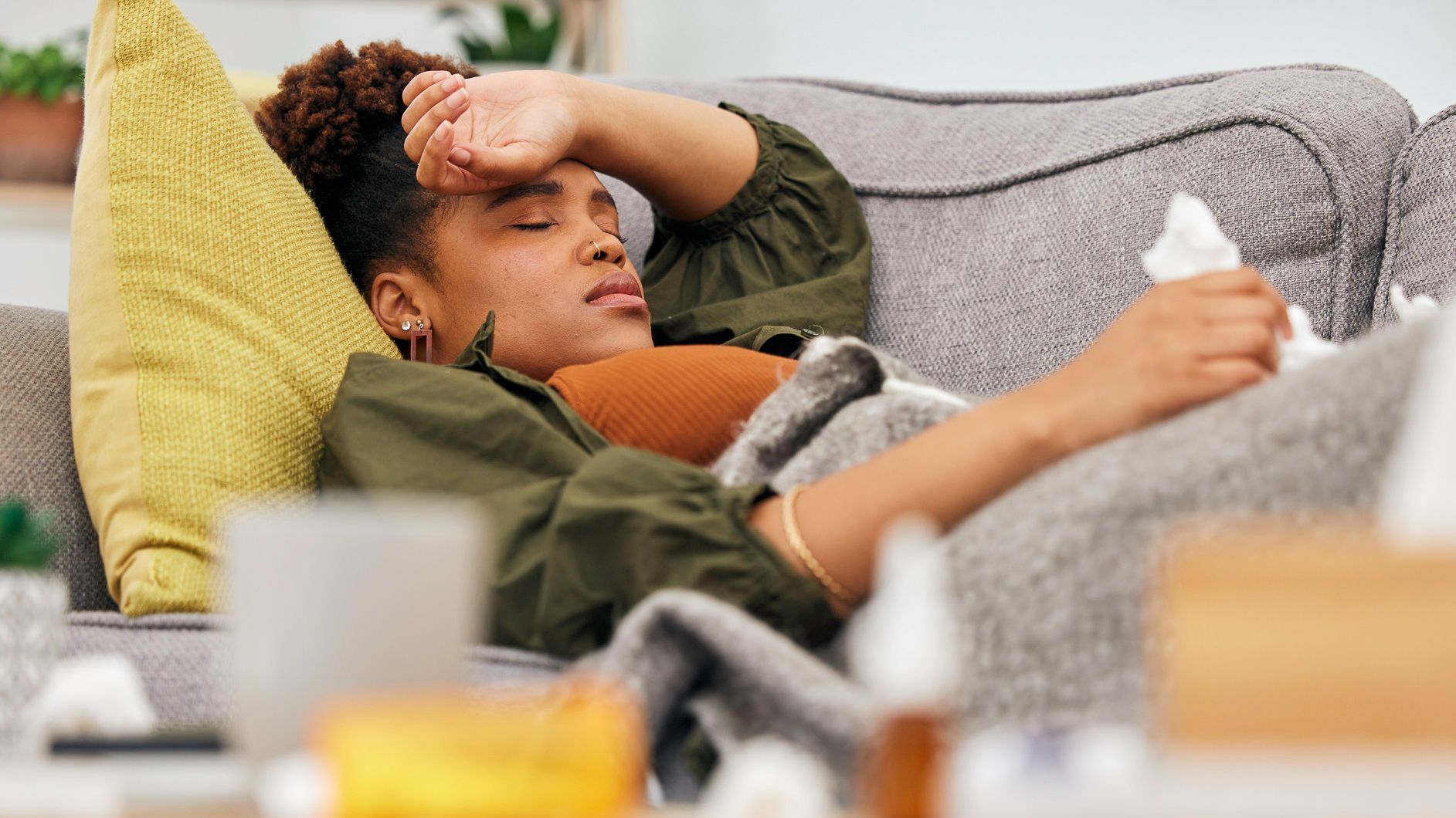 Woman lying on the couch feeling unwell