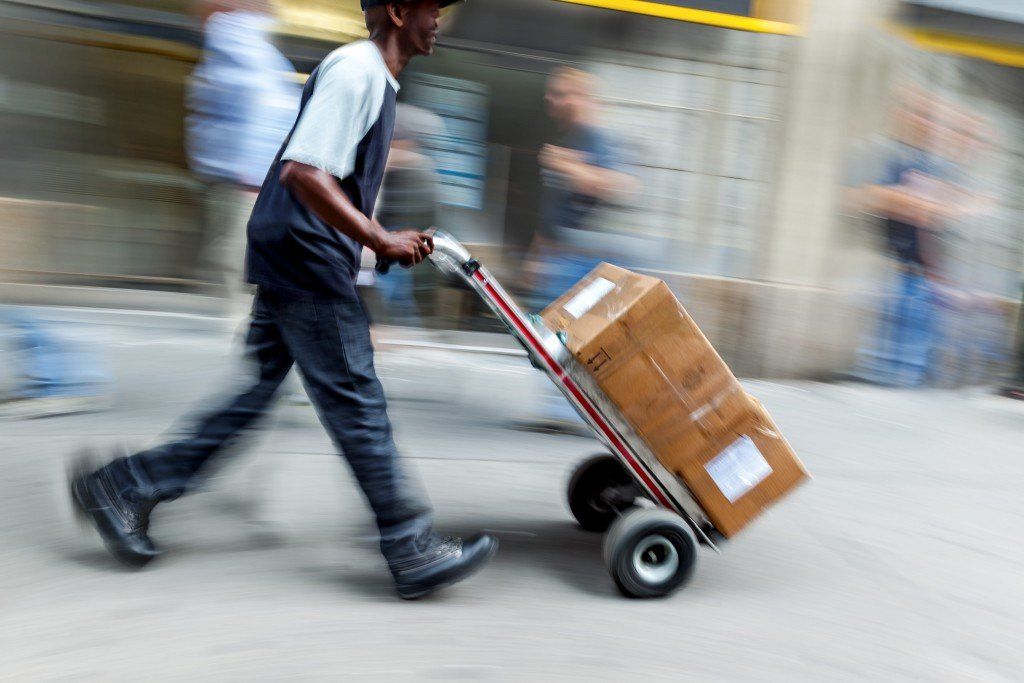Delivery Man Pushing Cart — Arlington, TX — Pronto Courier Delivery and Logistics