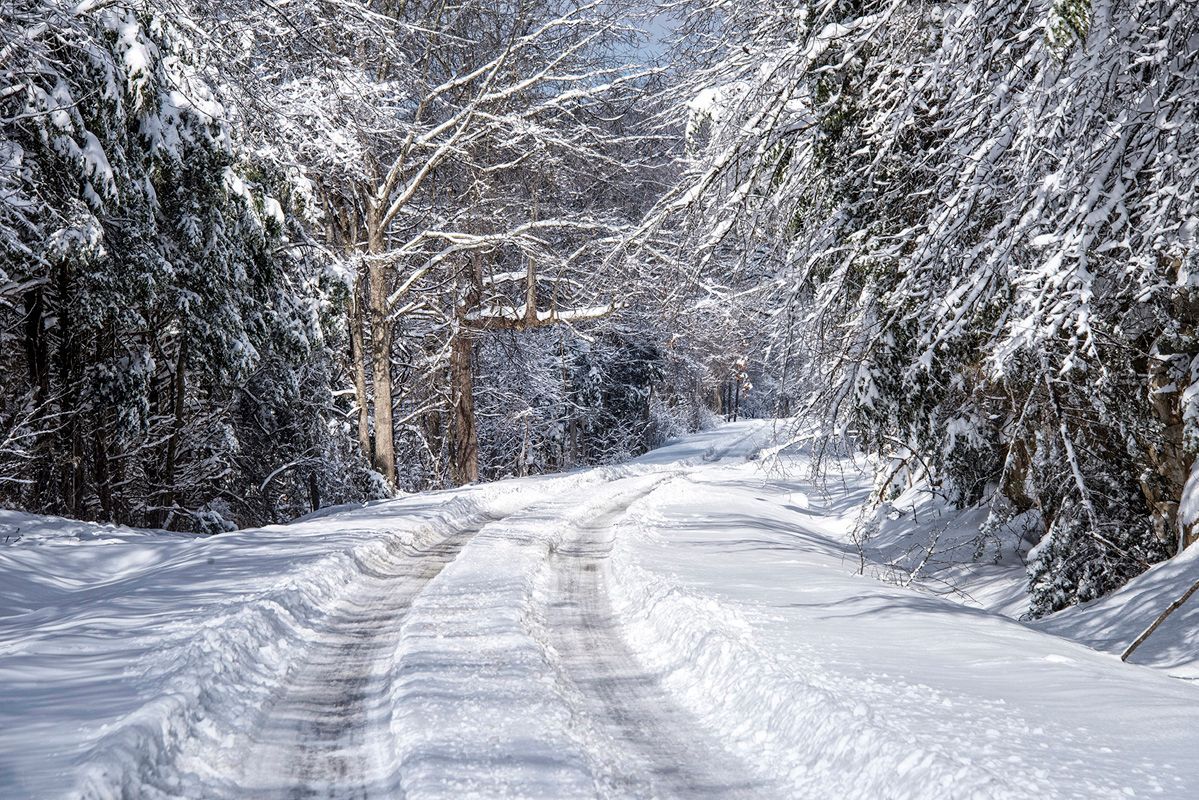 A large white building with a brown roof and a lot of windows.