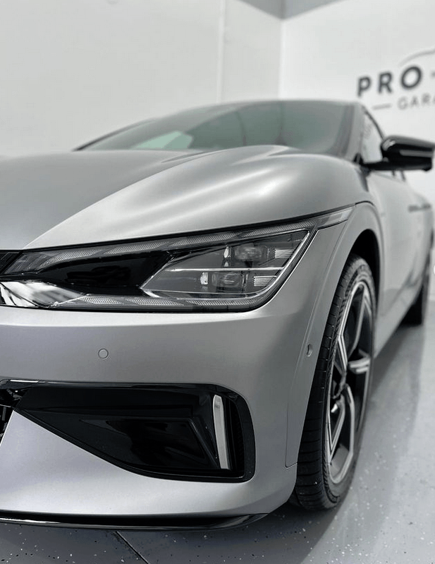 A gray KIA EV6 GT car in for ceramic coating in Rouse Hill with front bumper getting coated.