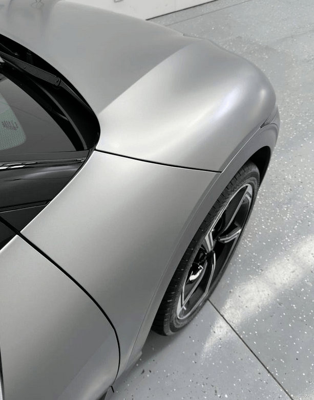 A gray KIA EV6 GT car in for ceramic coating in Rouse Hill with roof area getting coated.