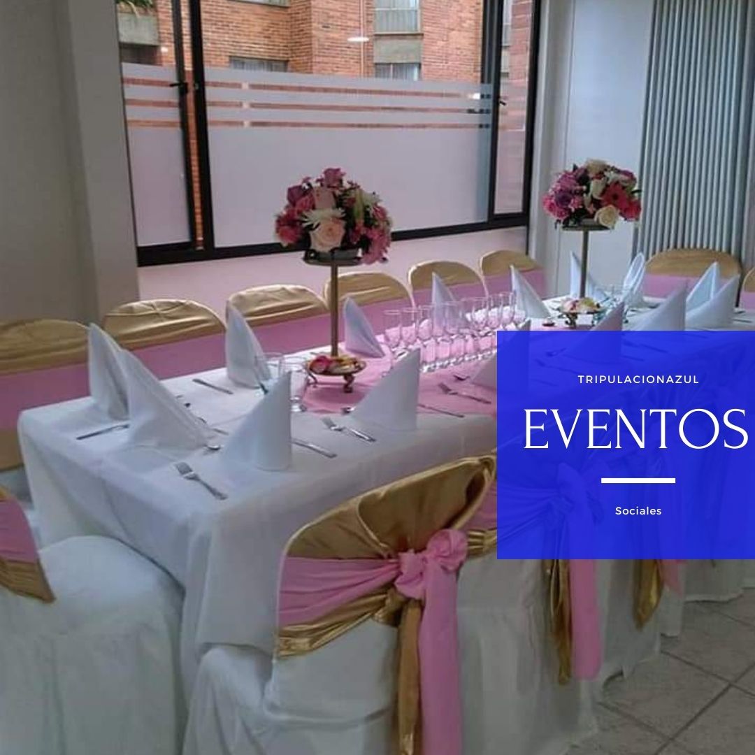 Elegante mesa para eventos con detalles en rosa y dorado, centros de mesa florales y mantelería blanca.