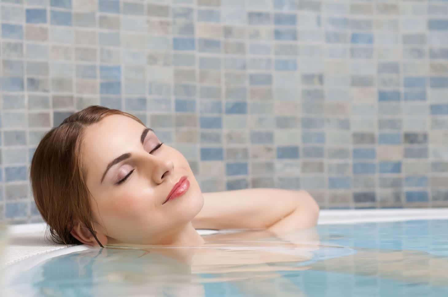Woman Relaxing in a Bathtub — Yorktown, VA — Anchor Pools & Spas