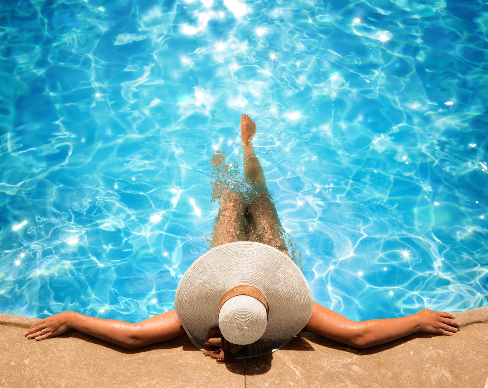A woman enjoying her pool in Hampton, VA after pool repair services