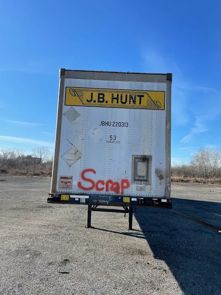 A man is sitting on a couch talking on a cell phone.