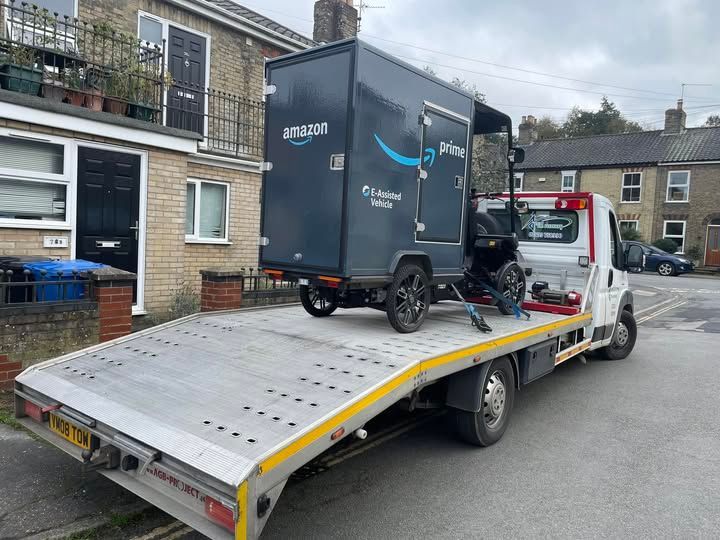 A tow truck with a trailer on the back of it.