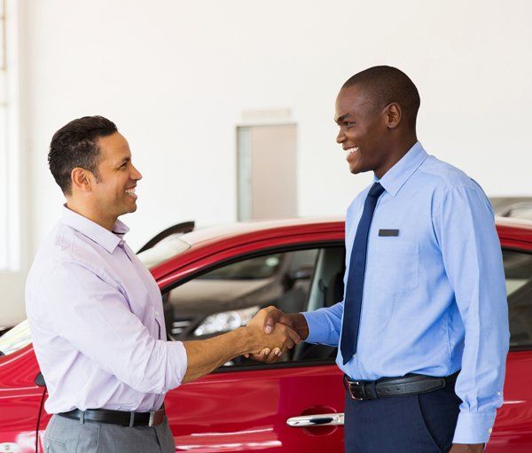 Vehicle Insurance — Shaking Hands in Car Showroom in Largo, MD
