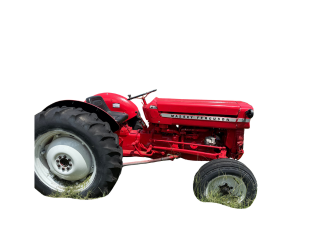 Red tractor with black tires, parked in grass.