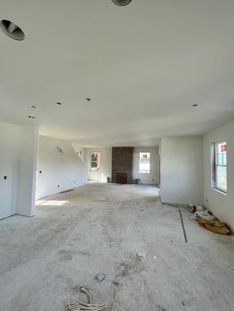 Empty room, newly constructed, with a fireplace