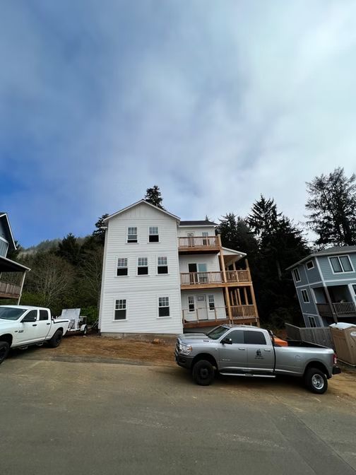 White multi-story building with wooden balconies