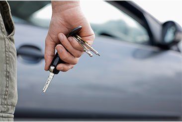 Hand with keys — DMV and Notary Services in Doylestown, PA